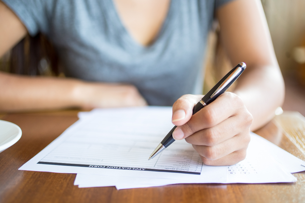 Person filling out eye care forms